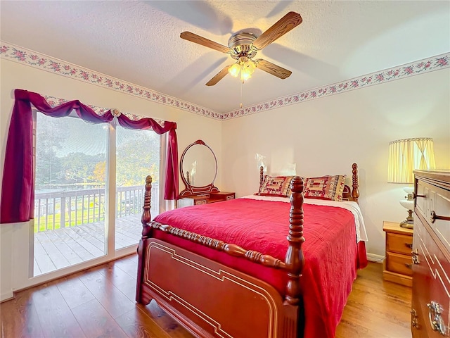 bedroom with hardwood / wood-style flooring, ceiling fan, a textured ceiling, and access to outside