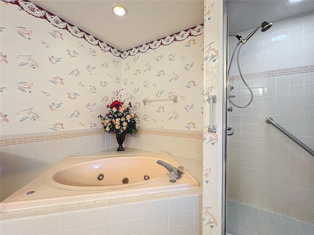 bathroom featuring shower with separate bathtub and a textured ceiling