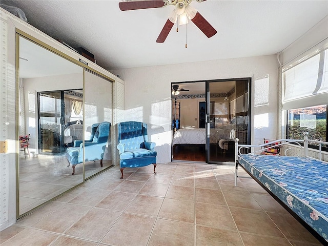 tiled bedroom featuring ceiling fan