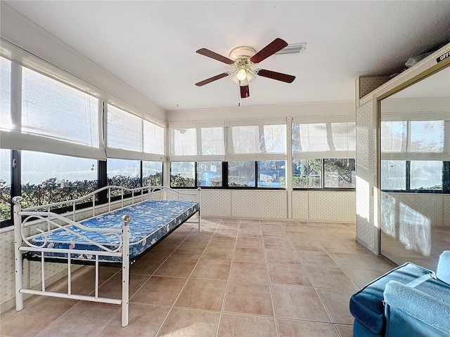 sunroom / solarium featuring ceiling fan