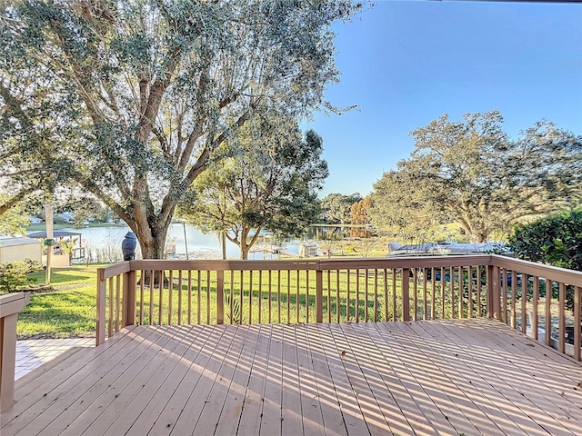 deck featuring a lawn and a water view