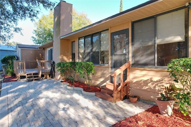 back of property featuring a patio area and a deck