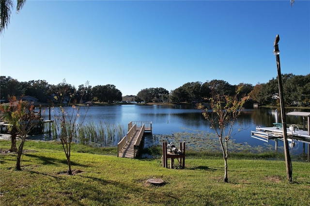 dock area featuring a yard and a water view