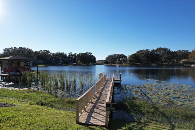 view of dock featuring a gazebo and a water view