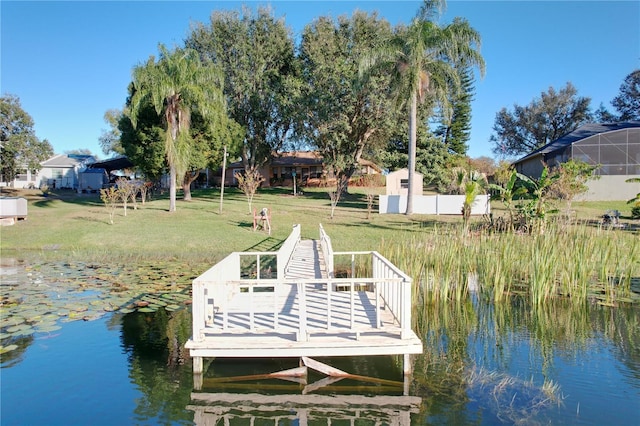 view of dock featuring a yard and a water view