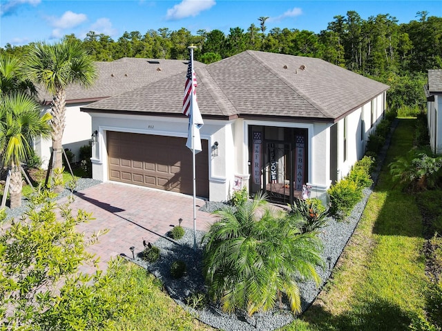 view of front of home featuring a front yard and a garage