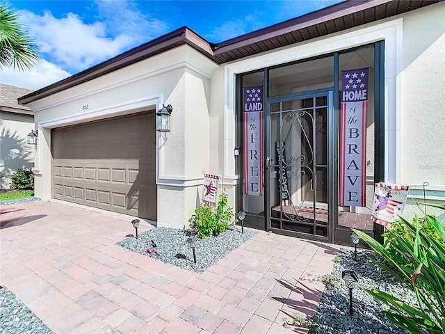 view of exterior entry with a garage