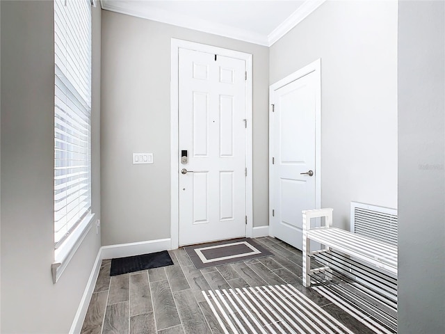 foyer entrance with dark hardwood / wood-style flooring and ornamental molding