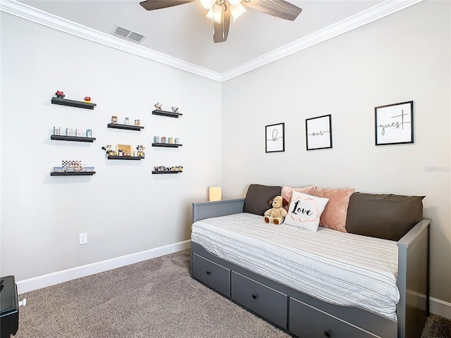 carpeted bedroom featuring ceiling fan and crown molding