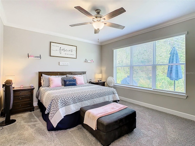 carpeted bedroom with multiple windows, ceiling fan, and ornamental molding