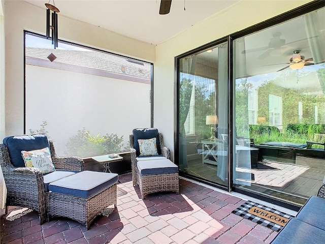 sunroom / solarium featuring ceiling fan