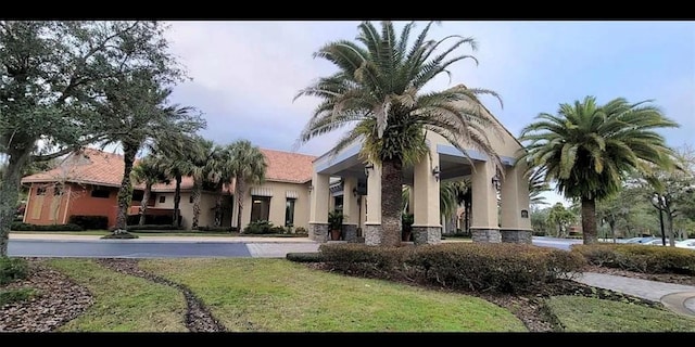 back of property featuring a lawn