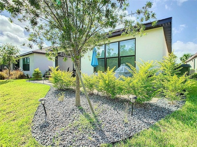 view of property exterior featuring a lawn