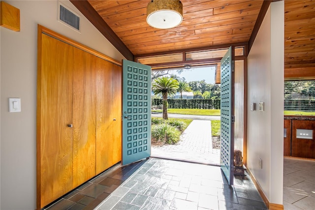 foyer with wood ceiling and vaulted ceiling