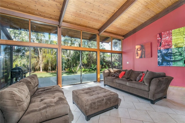 living room featuring beamed ceiling, light tile patterned floors, wooden ceiling, and a healthy amount of sunlight