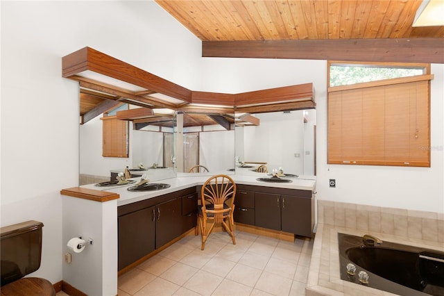 bathroom featuring wooden ceiling, vaulted ceiling with beams, tile patterned floors, a bathtub, and vanity