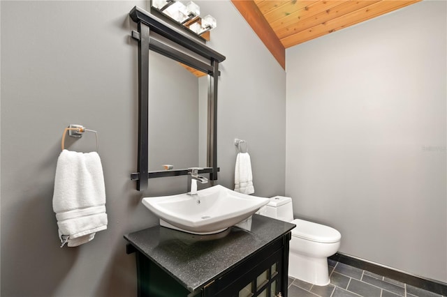 bathroom with vanity, wood ceiling, vaulted ceiling, and toilet