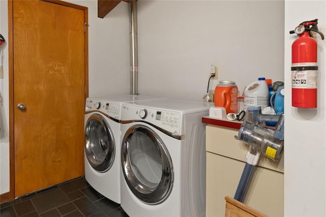 washroom featuring dark tile patterned flooring and washer and clothes dryer