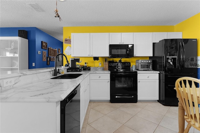 kitchen featuring light stone countertops, a textured ceiling, sink, black appliances, and white cabinetry