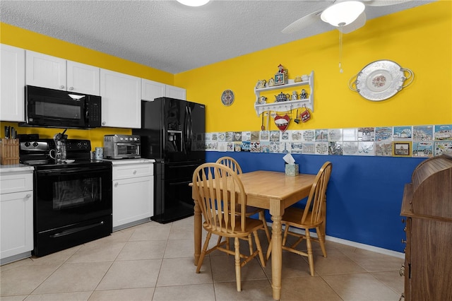 kitchen with white cabinets, a textured ceiling, light tile patterned flooring, and black appliances