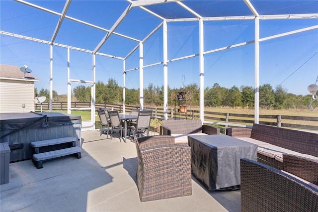 view of patio with a lanai and a hot tub