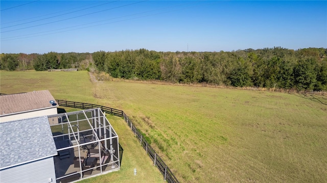 view of yard with a rural view and glass enclosure