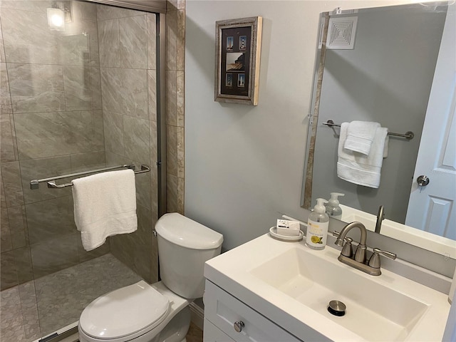 bathroom with vanity, toilet, tiled shower, and a baseboard radiator