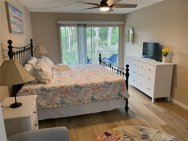 bedroom with light hardwood / wood-style floors and ceiling fan