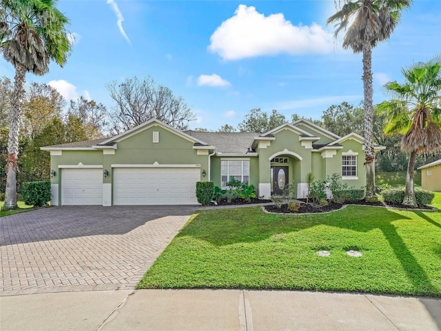 ranch-style house with a garage and a front yard