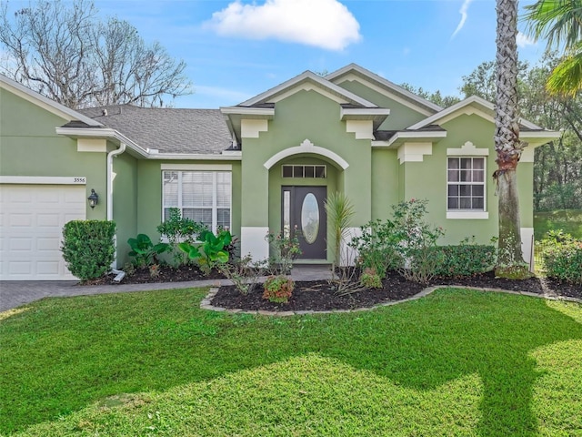 view of front of home with a garage and a front yard