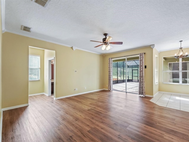 empty room with crown molding and hardwood / wood-style floors