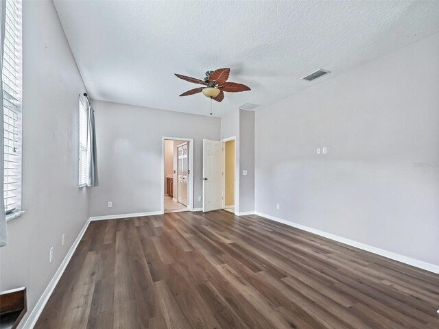 unfurnished room featuring a textured ceiling, ceiling fan, and dark hardwood / wood-style floors