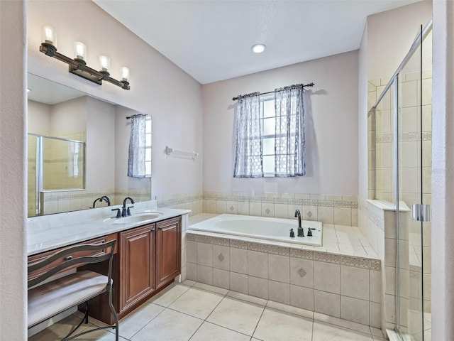 bathroom featuring shower with separate bathtub, vanity, and tile patterned floors