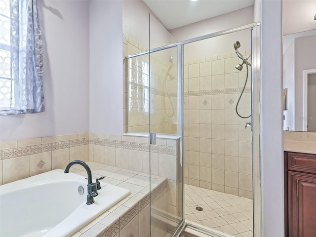 bathroom featuring vanity and shower with separate bathtub