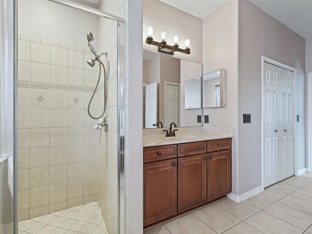 bathroom with tile patterned floors, vanity, and an enclosed shower