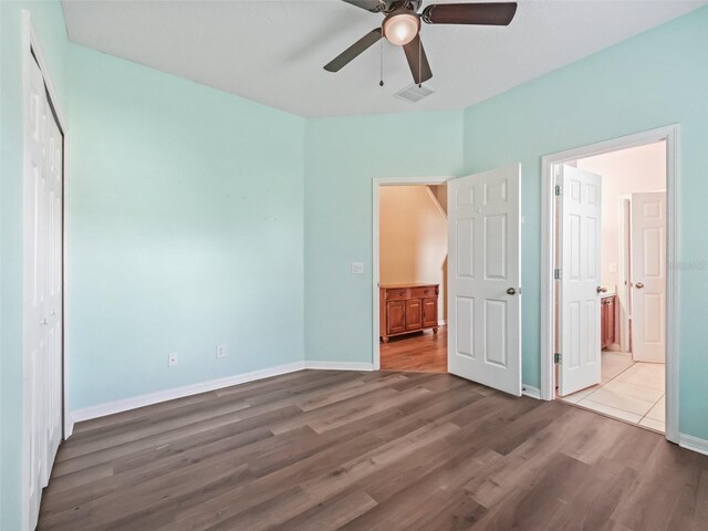 unfurnished bedroom featuring hardwood / wood-style flooring and ceiling fan