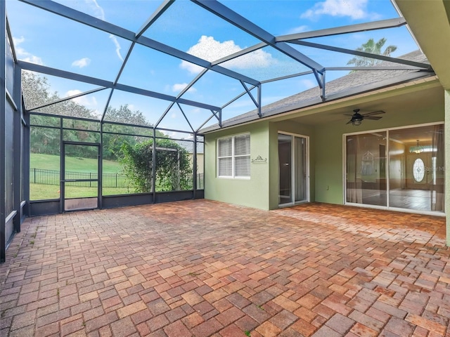 view of patio / terrace with ceiling fan and a lanai