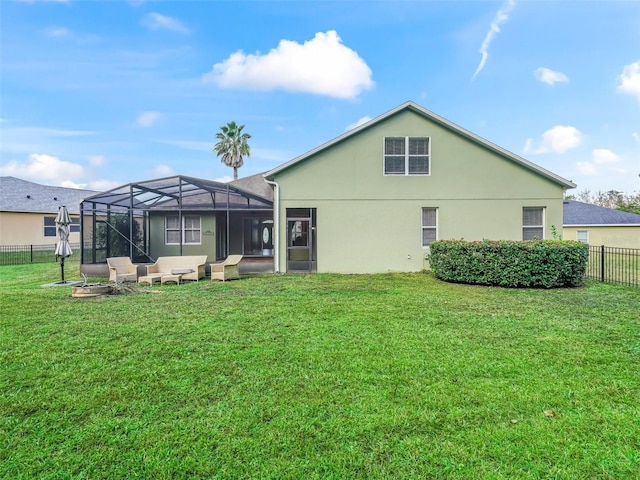 back of property featuring a lanai and a yard