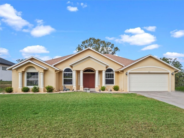 single story home with a garage and a front lawn