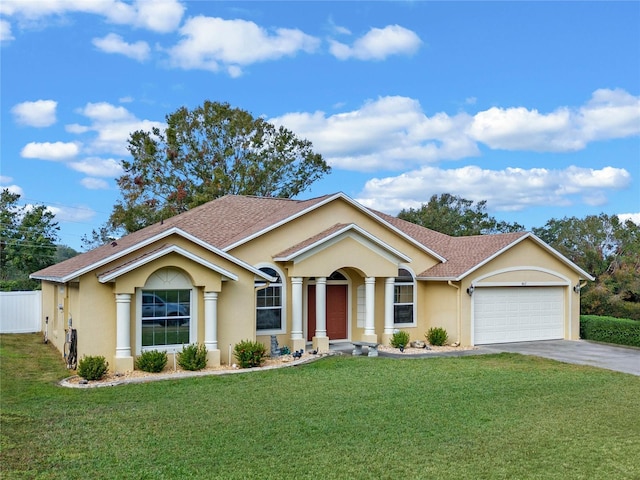 ranch-style home featuring a garage and a front lawn