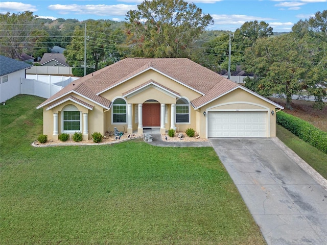 view of front of house with a front yard and a garage