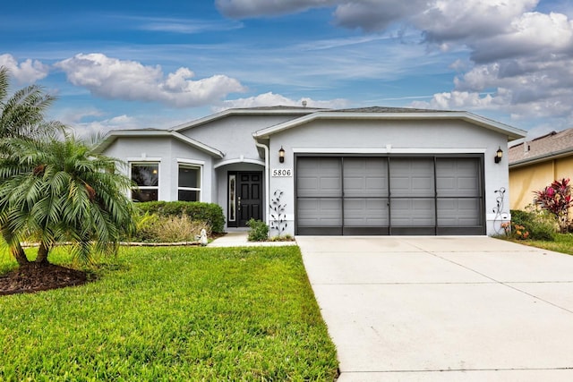 single story home featuring a front yard and a garage