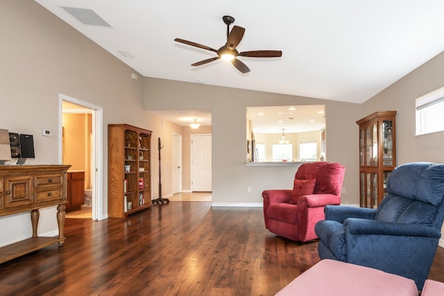 living room featuring a wealth of natural light, ceiling fan, dark wood-type flooring, and lofted ceiling