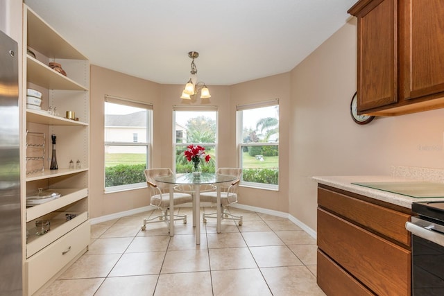 dining area with light tile patterned flooring and a chandelier