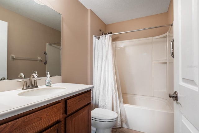 full bathroom featuring tile patterned flooring, a textured ceiling, toilet, shower / bath combo with shower curtain, and vanity