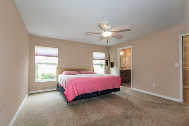 carpeted bedroom featuring ceiling fan and connected bathroom