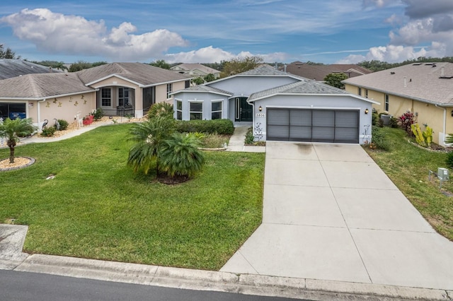 ranch-style house featuring a garage and a front lawn