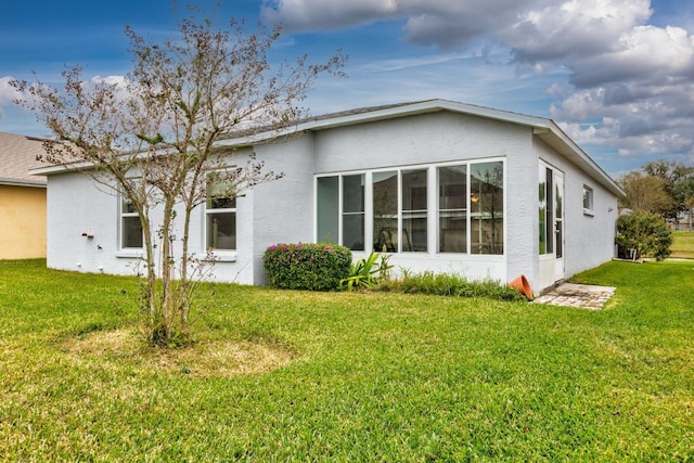 back of house with a lawn