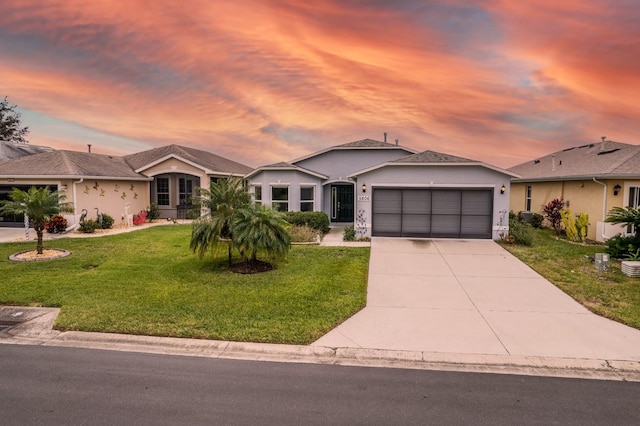 single story home with a yard and a garage