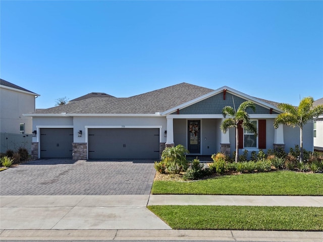 view of front of house with a garage and a front lawn